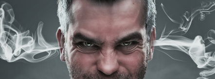 Close up of angry man with steam coming out from his ears
